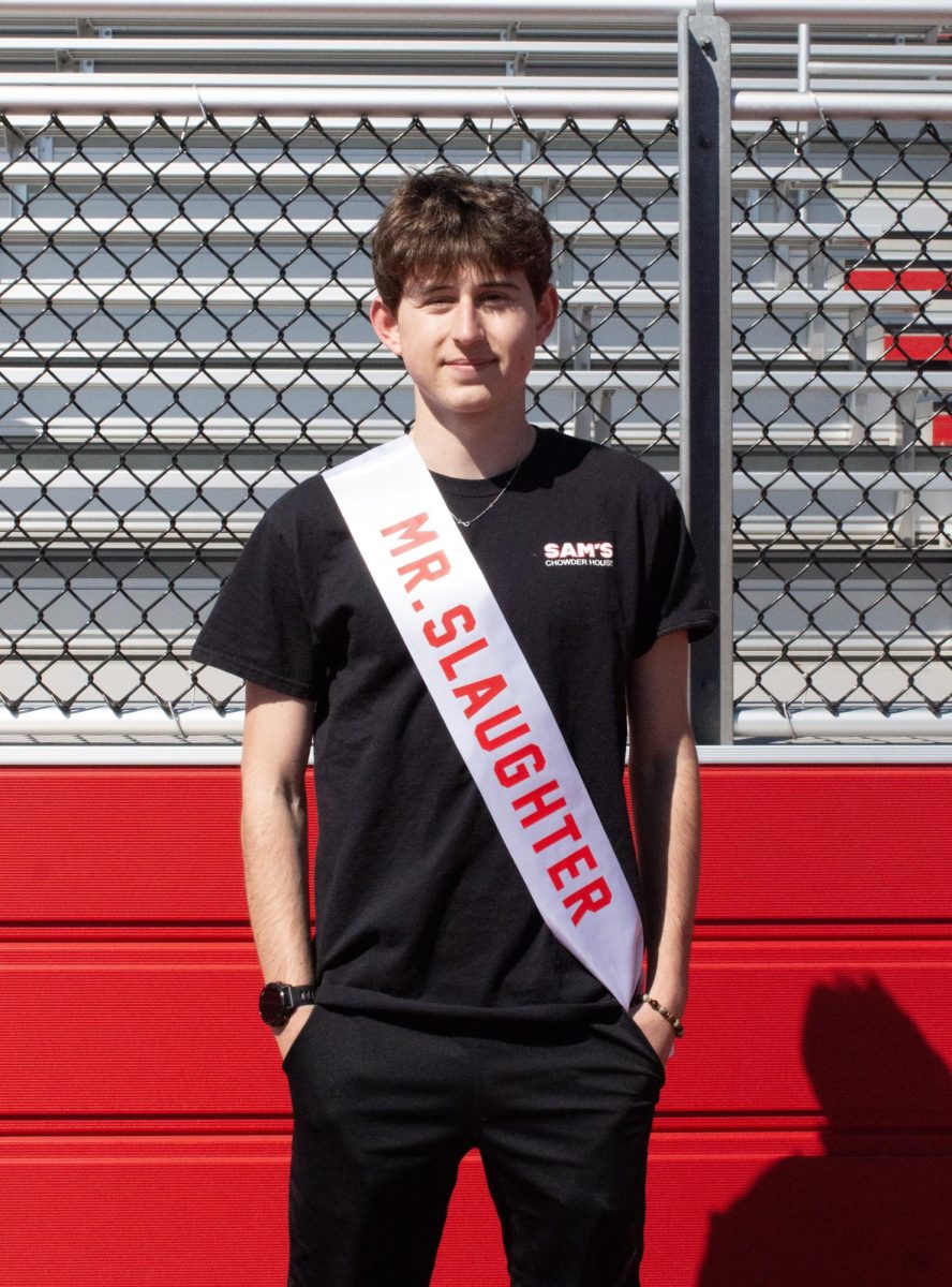 Ben Sautter ('26) poses for a photo with his Mr. East sash, assuming the identity of Mr. Slaughter.