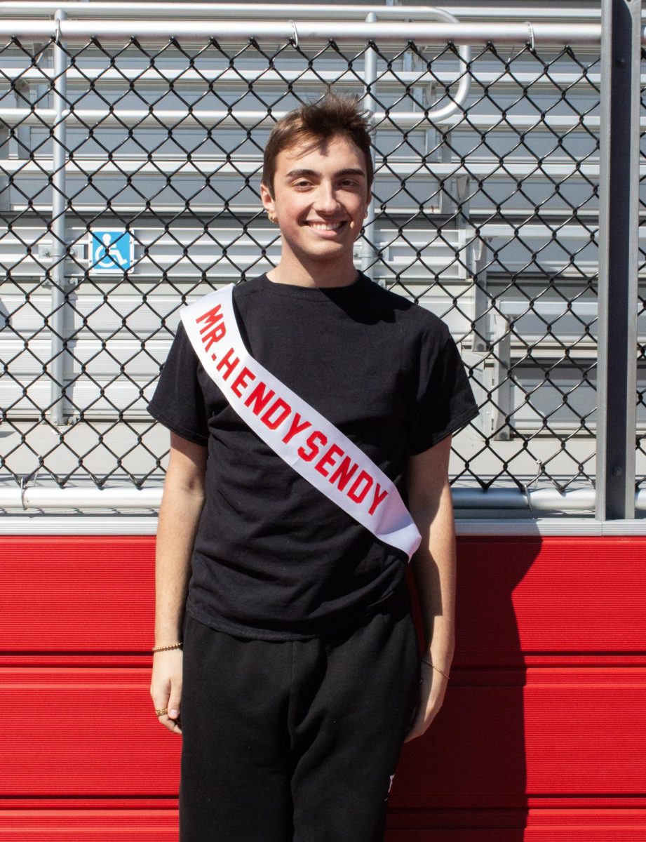 Brad Hendricks ('26) poses for a photo with his Mr. East sash, assuming the identity of Mr. Hendy Sendy.