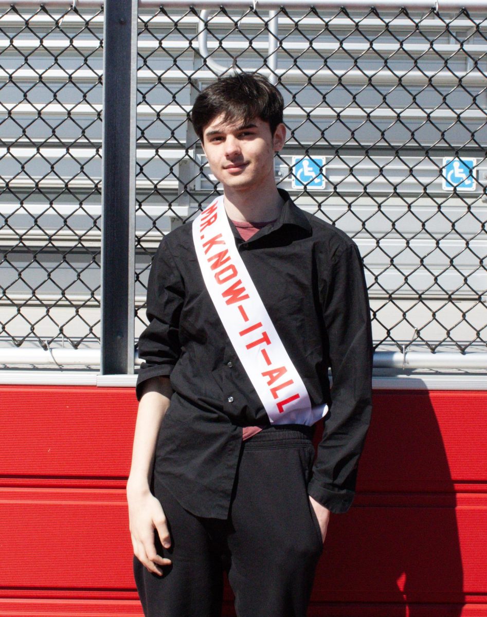 Nico Spatucci ('26) poses for a photo with his Mr. East sash, assuming the identity of Mr. Know-it-all.