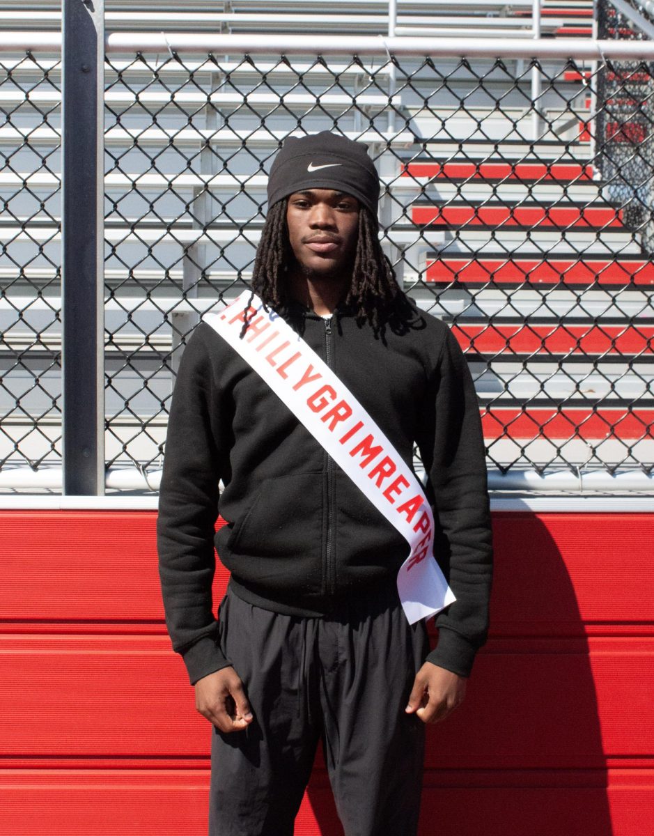 Tymir Gayle ('26) poses for a photo with his Mr. East sash, assuming the identity of Mr. Philly Grim Reaper.