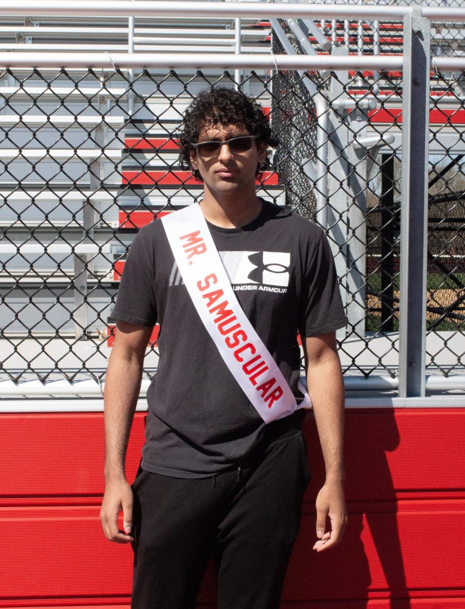 Sameel Hussain ('26) poses for a photo with his Mr. East sash, assuming the identity of Mr. Samuscular.