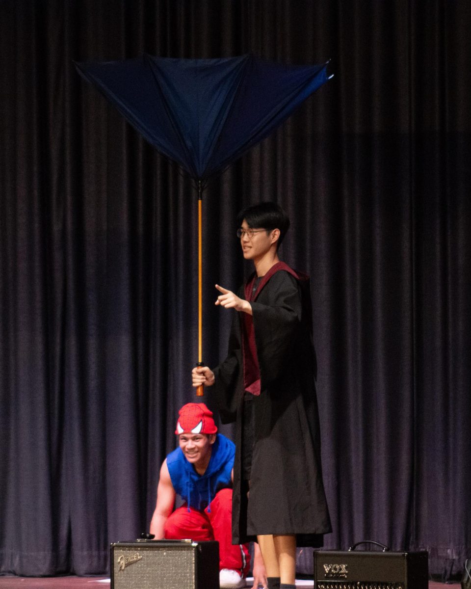 Mr. Linsanity opens his umbrella inside out in the first act of Mr. East.