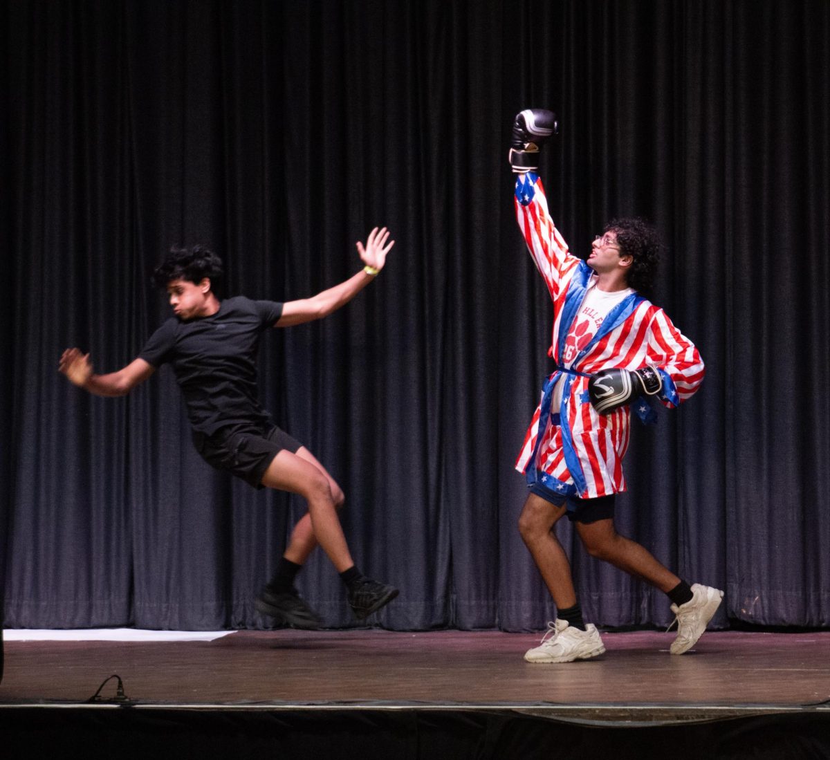 Mr. Samuscular pretends to punch one of the members of his act.