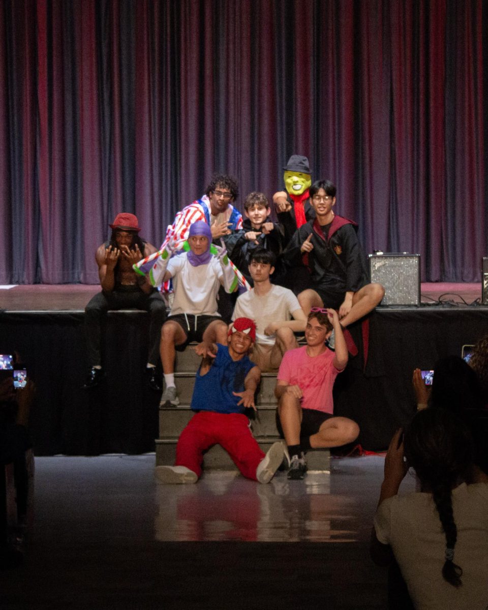 The Mr. East contestants pose on the stage at the end of the opening act of the show.