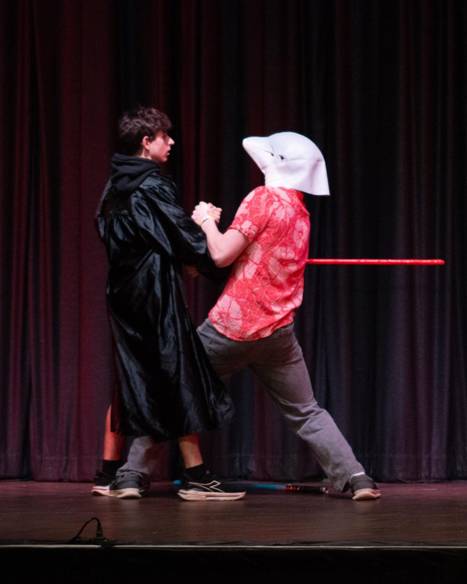 Mr. Slaughter attacks a dolphin man with a lightsaber.