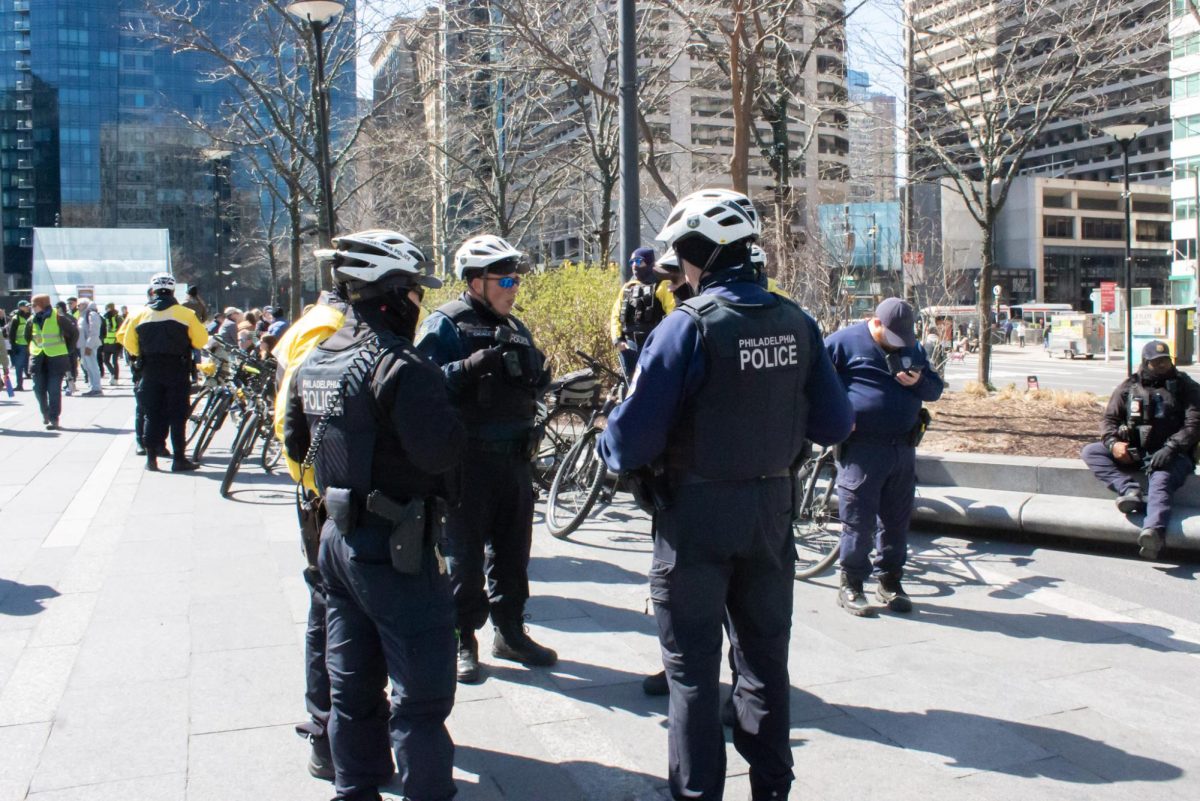 Police stand outside of Philadelphia City Hall, providing security for the No Kings protest on March 28. 