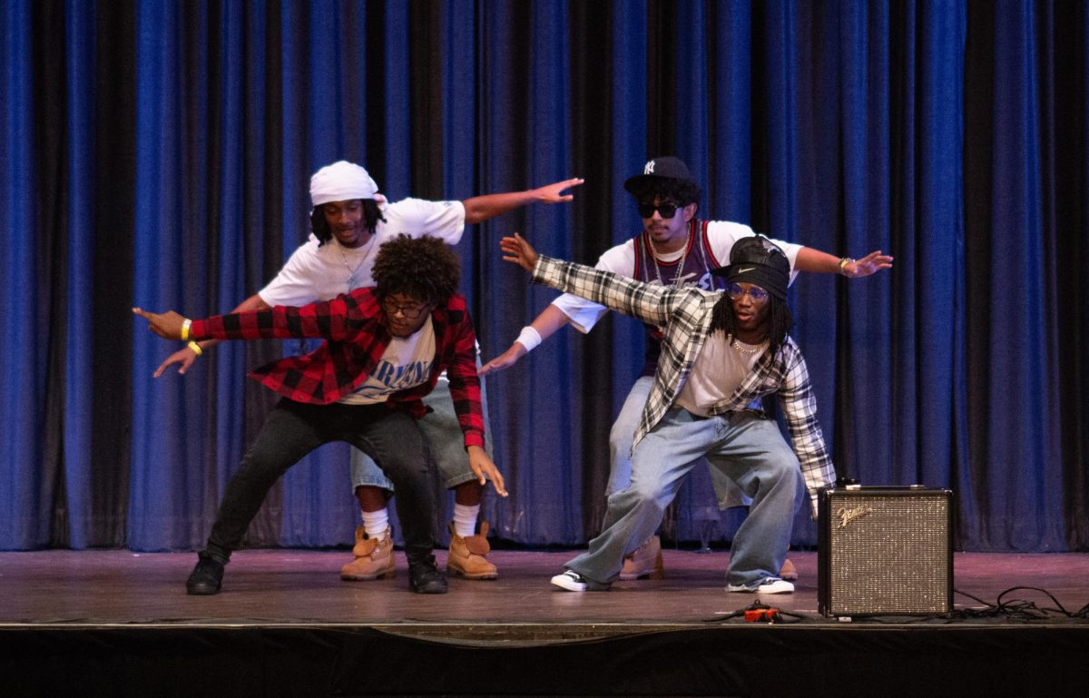 Mr. Philly Grim Reaper dances with members of his act.