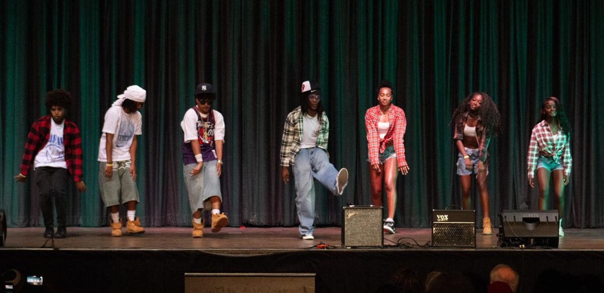 Mr. Philly Grim Reaper dances with the members of his act.
