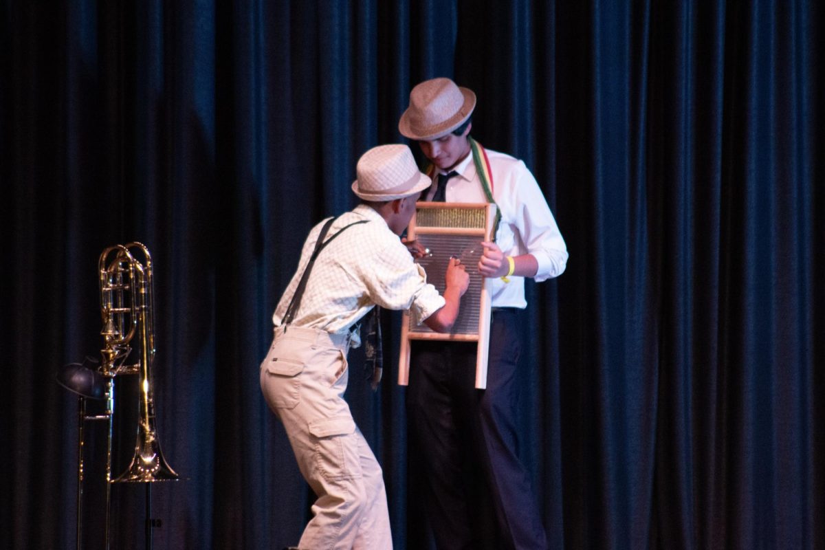 Mr. Renaissance man teaches a member of his act how to play the washboard.