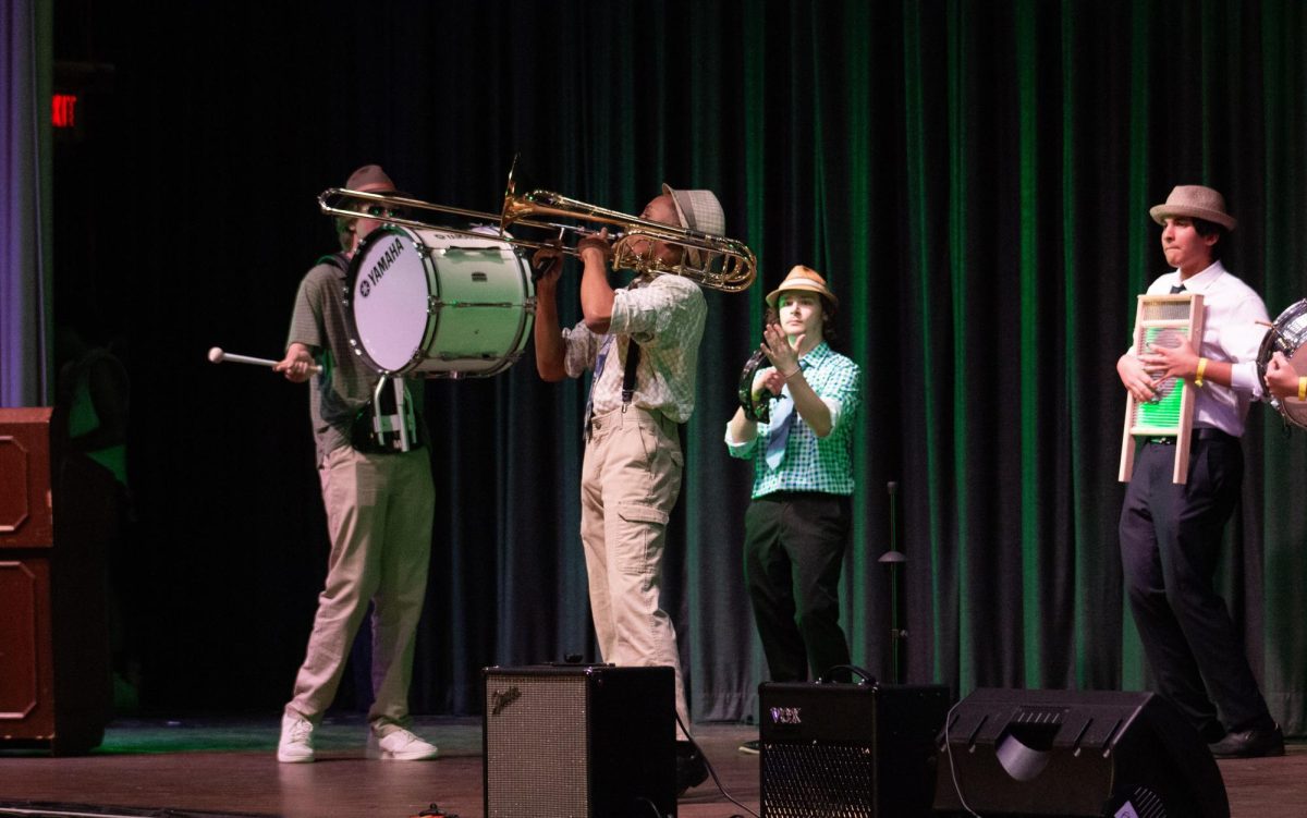 Mr. Renaissance Man performs a jazz solo after teaching members of his act how to play different accompanying instruments. 