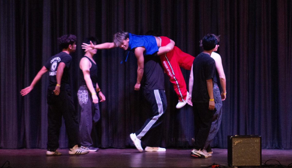 Mr. Buco is carried away at the end of his act by the members of his performance.