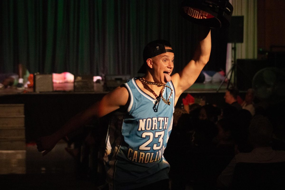 Mr. Buzz runs up the center aisle after winning a fight and receiving a belt.