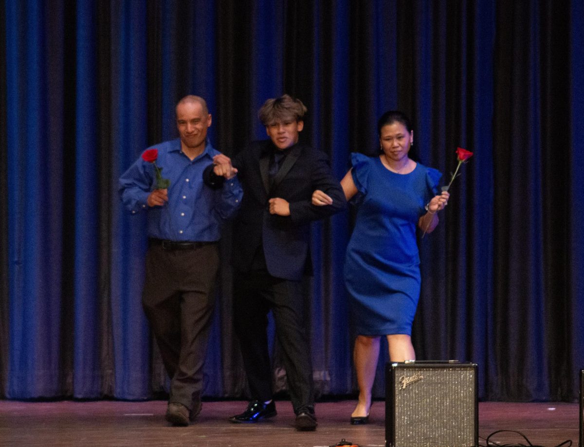 Mr. Buco dances with his parents after giving them roses in one of the closing acts of the night.