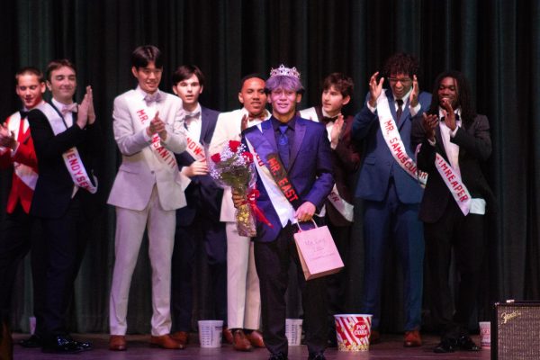 Mr. Buco is crowned Mr. East and receives his flowers and prize.