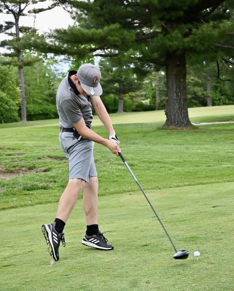 Tyler Whitney ('27) hits his driver off the tee on the par-5 fourth hole.