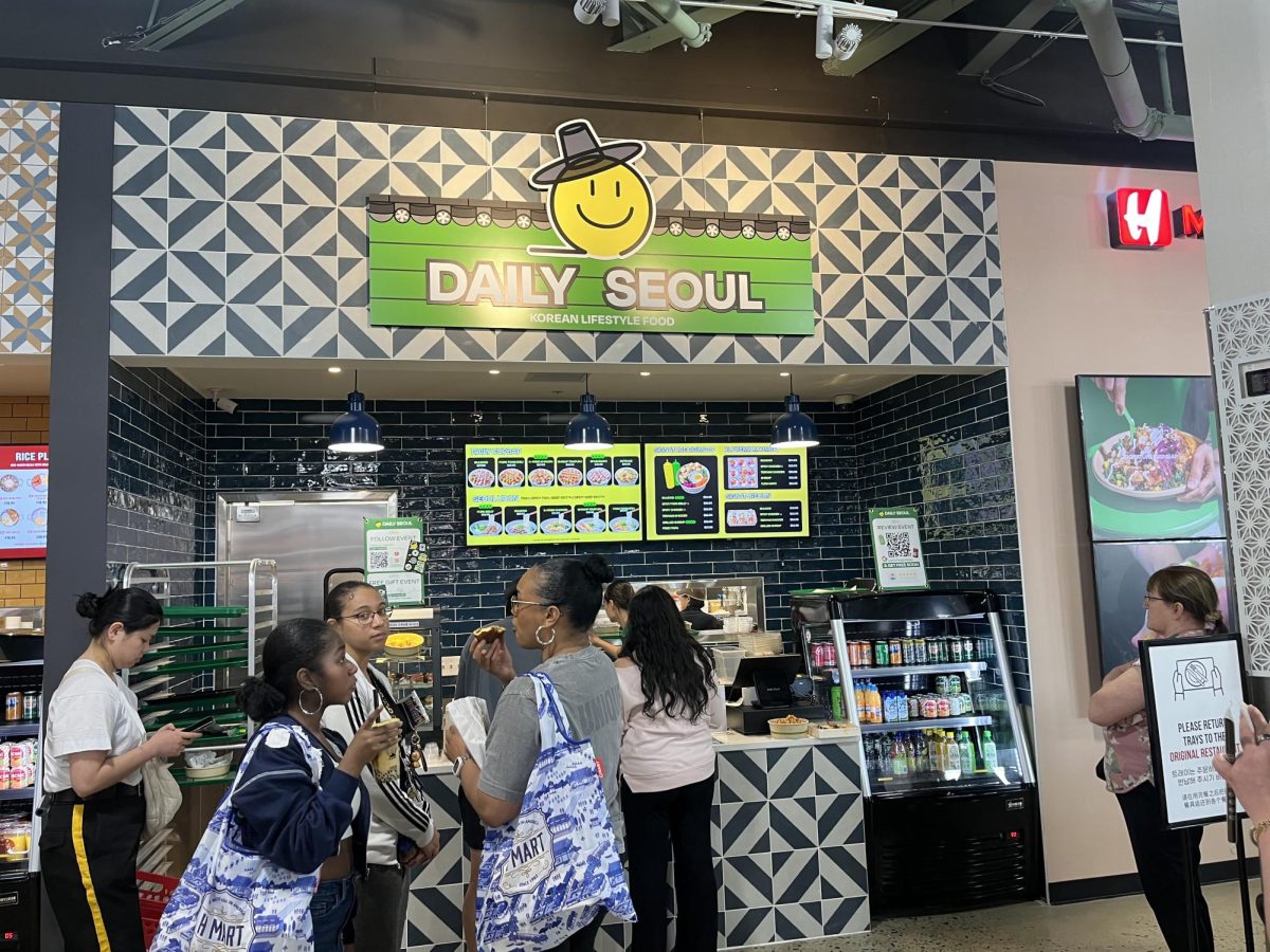 Customers glance at the menu as they wait to purchase Korean lifestyle food from Daily Seoul.