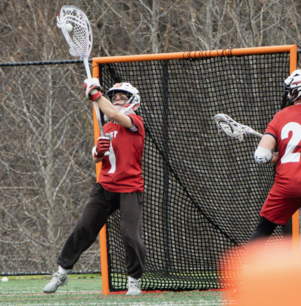 Josh Hammer ('26) saves the ball during a lacrosse game.