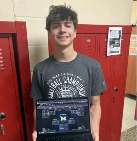 Zach Kellerman ('28) poses with his winning bracket for March Madness.