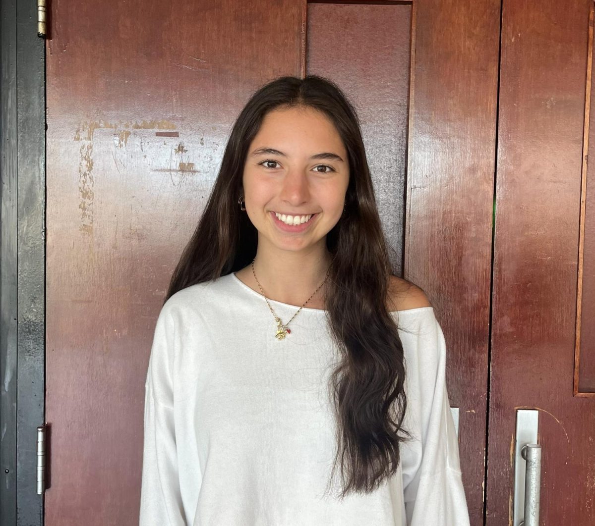 Rachel Rosenberg ('26) poses in front of the auditorium doors. 
